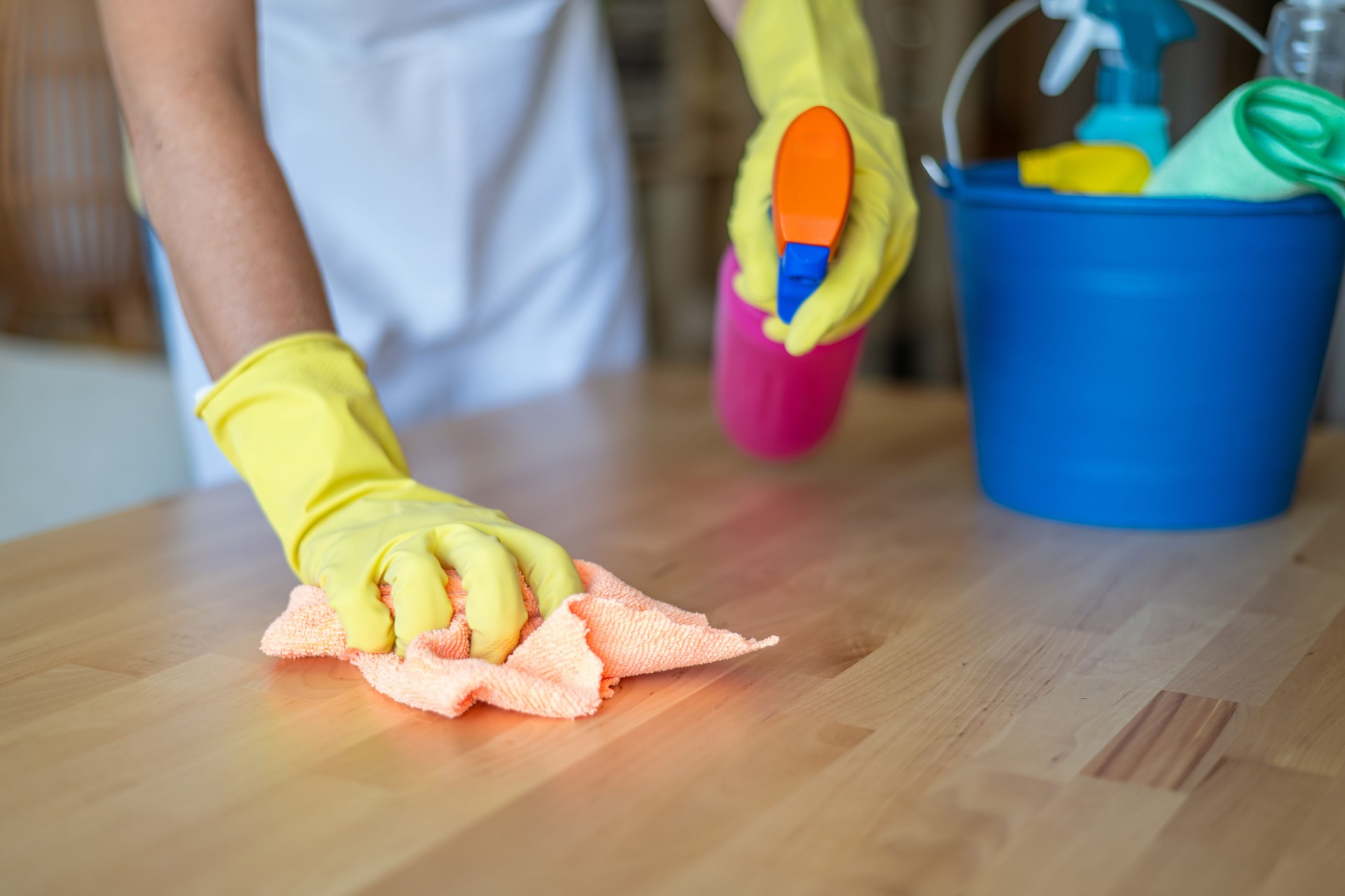 Professional Home Cleaning Service Concept With Cleaning Supplies And Worker In Protective Gloves Wiping Surface With Cloth.Home Cleaning Concept